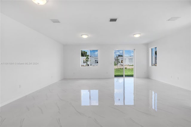 spare room featuring light tile patterned flooring