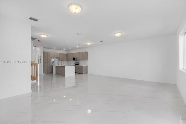 unfurnished living room featuring light tile patterned floors