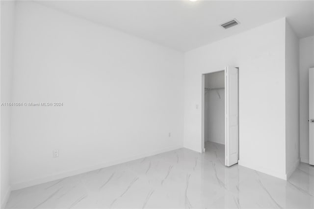 unfurnished bedroom featuring light tile patterned floors and a closet