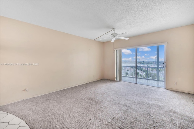 unfurnished room featuring ceiling fan, carpet floors, and a textured ceiling