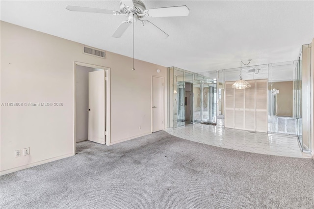 carpeted empty room featuring ceiling fan