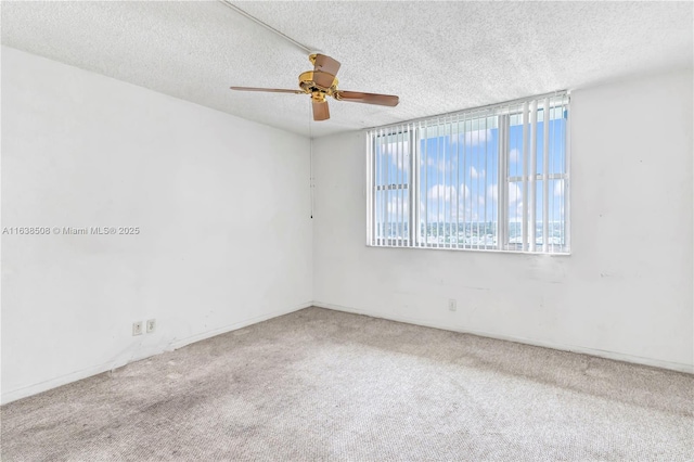 spare room with ceiling fan, carpet floors, and a textured ceiling