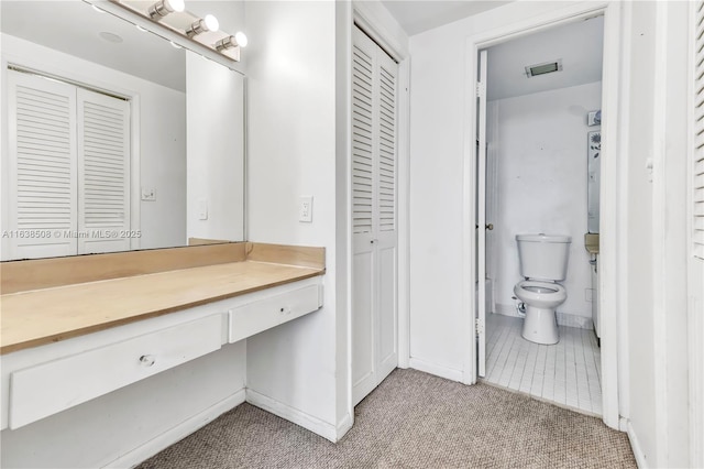 bathroom with vanity, tile patterned flooring, and toilet