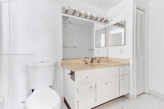 bathroom with vanity, toilet, and tile patterned flooring