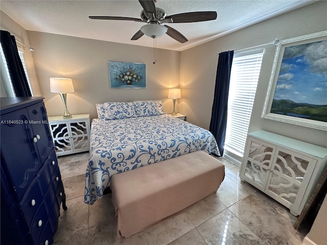 bedroom featuring light tile patterned floors and ceiling fan