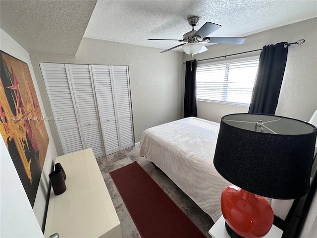 bedroom featuring a textured ceiling, a closet, and ceiling fan