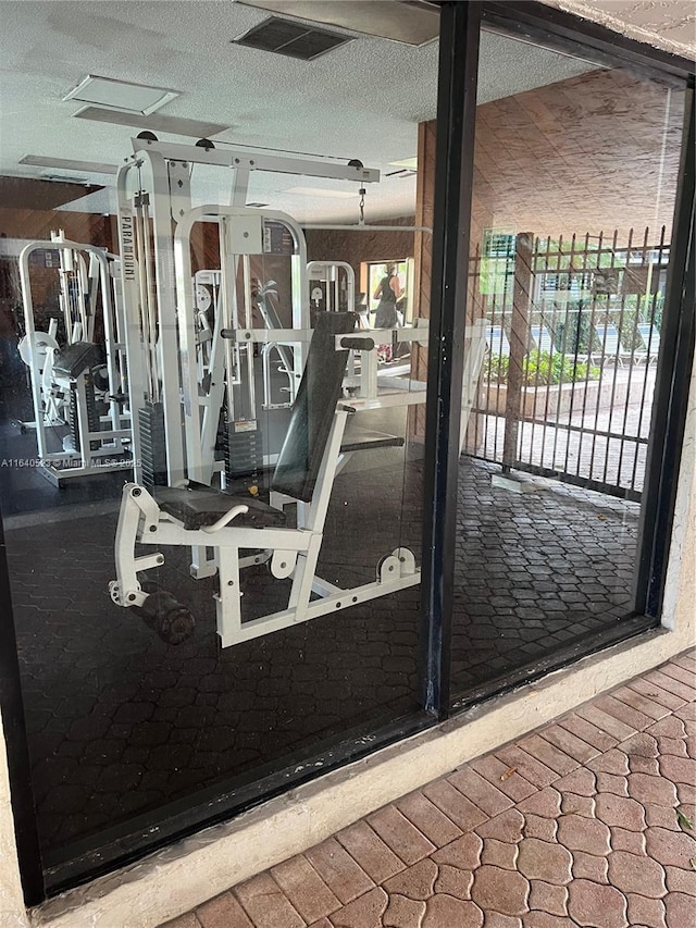 workout area with a textured ceiling