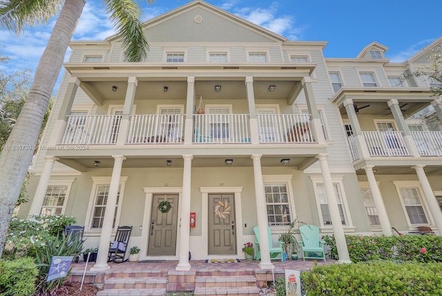 multi unit property with covered porch and a balcony