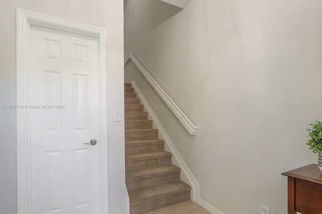 stairs featuring tile patterned floors