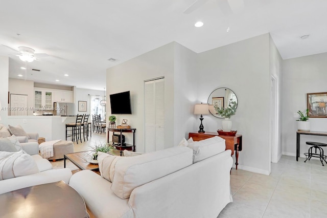 living room featuring ceiling fan and light tile patterned floors