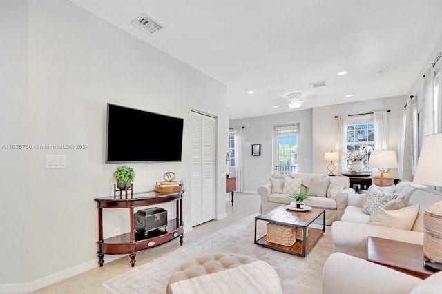 tiled living room featuring ceiling fan