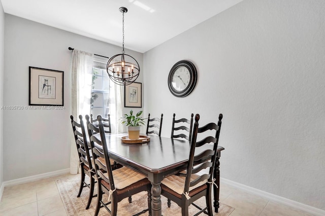 tiled dining room featuring an inviting chandelier