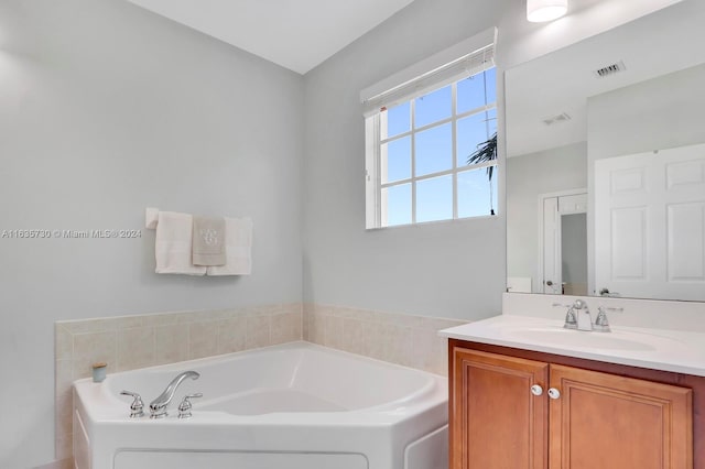 bathroom featuring vanity and a bath