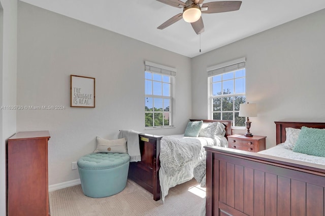 carpeted bedroom featuring multiple windows and ceiling fan