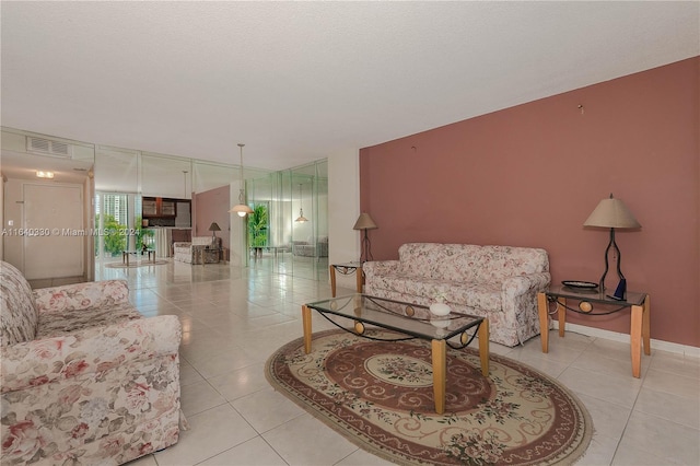 tiled living room featuring a textured ceiling