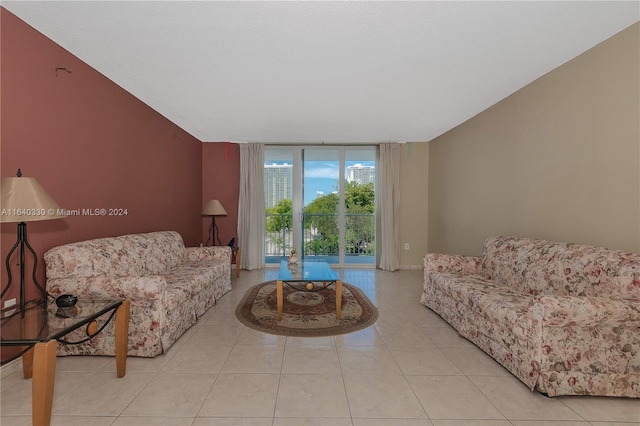 living room featuring light tile patterned floors and a wall of windows