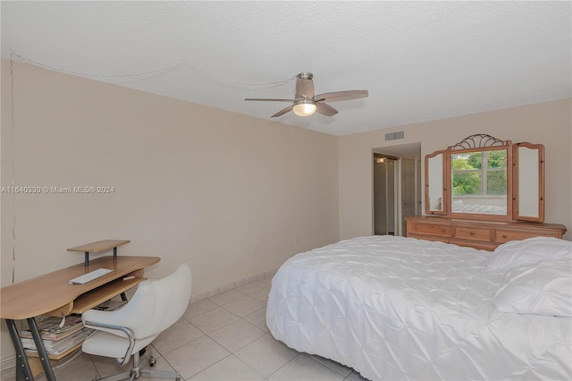 tiled bedroom featuring a textured ceiling and ceiling fan