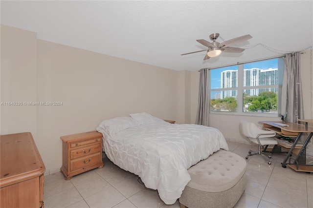 tiled bedroom featuring ceiling fan