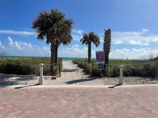 surrounding community featuring volleyball court and a water view