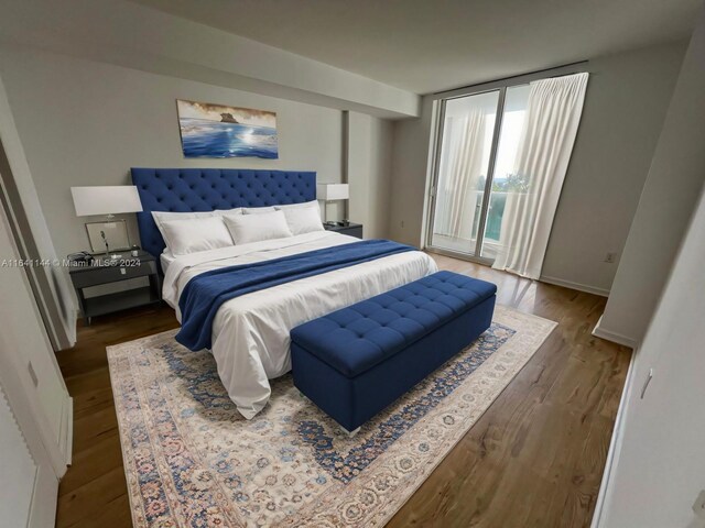 bedroom with baseboards, access to outside, and wood finished floors