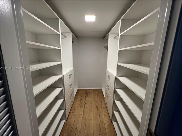 walk in closet featuring light hardwood / wood-style flooring