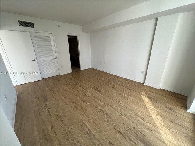 10275 Collins Ave Unit 415, Bal Harbour, FL 33154 - unfurnished bedroom featuring wood finished floors and baseboards