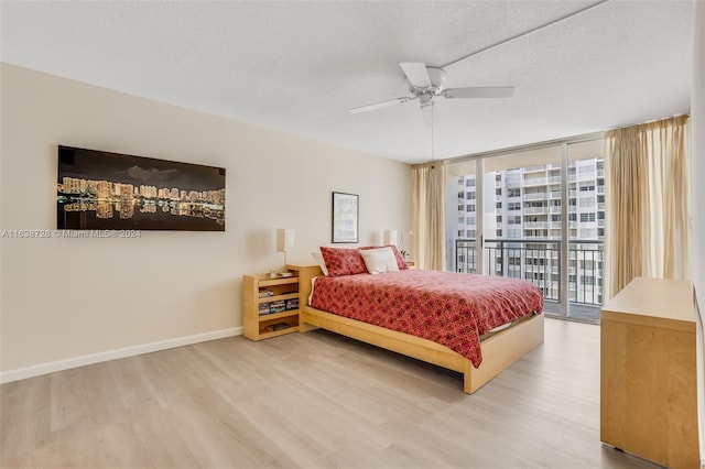 bedroom featuring access to outside, ceiling fan, a textured ceiling, and light wood-type flooring