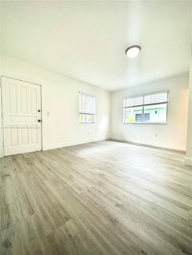 unfurnished room with light wood-type flooring