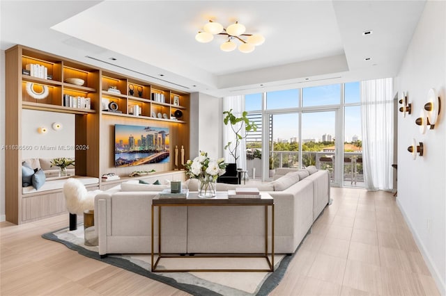 tiled living room with a raised ceiling and expansive windows