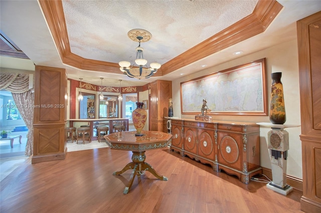 2941 Paddock Ln, Weston, FL 33331 - home office with a tray ceiling, light wood-style flooring, healthy amount of natural light, a chandelier, and crown molding