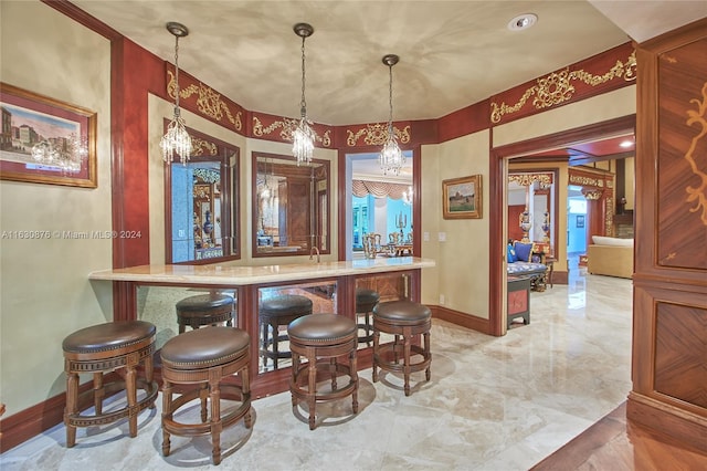 bar with light tile patterned flooring, a notable chandelier, and decorative light fixtures