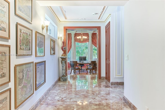 corridor featuring a notable chandelier, ornamental molding, and tile patterned flooring