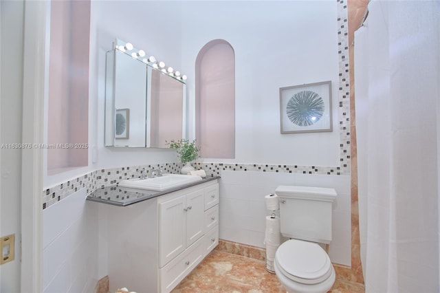 2941 Paddock Ln, Weston, FL 33331 - bathroom with tile walls, vanity, toilet, a wainscoted wall, and a shower with curtain