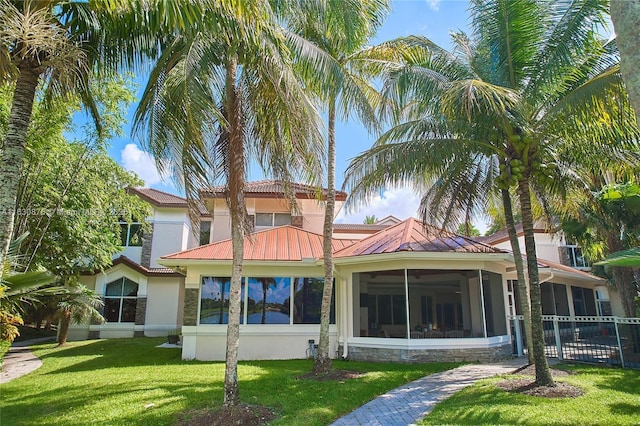 2941 Paddock Ln, Weston, FL 33331 - back of property featuring stucco siding, a standing seam roof, a sunroom, and stone siding