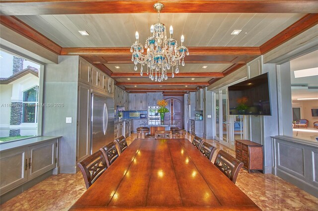 corridor featuring crown molding, wood-type flooring, and an inviting chandelier