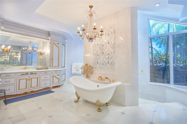 bathroom with a chandelier, vanity, a bathtub, and tile patterned flooring