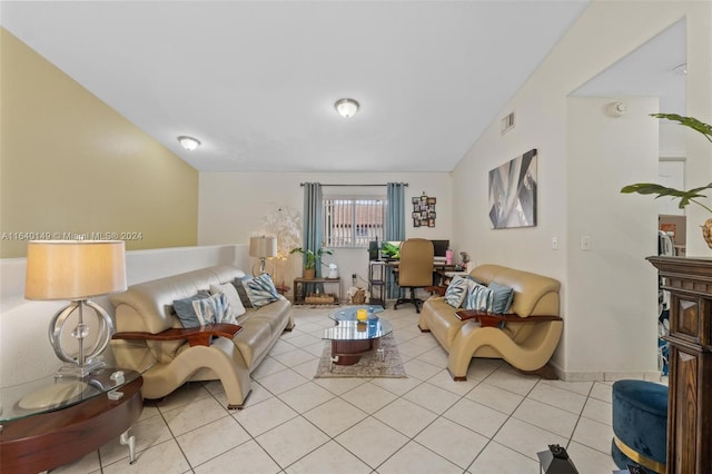 living room featuring vaulted ceiling and light tile patterned floors