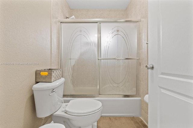 full bathroom featuring tile patterned floors, bath / shower combo with glass door, ceiling fan, vanity, and toilet