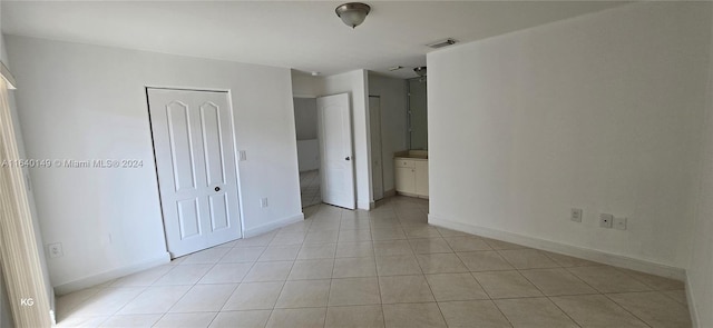 unfurnished room with light tile patterned floors