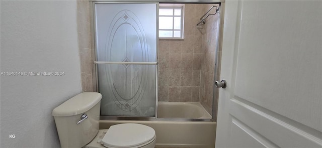 bathroom with shower / bath combination with glass door and toilet