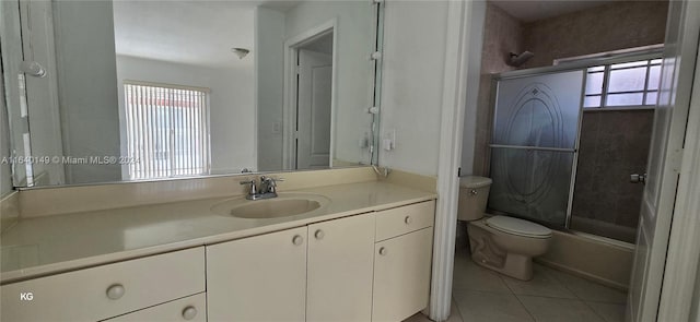 full bathroom with vanity, toilet, combined bath / shower with glass door, and tile patterned floors