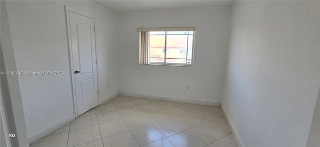 empty room with light tile patterned floors