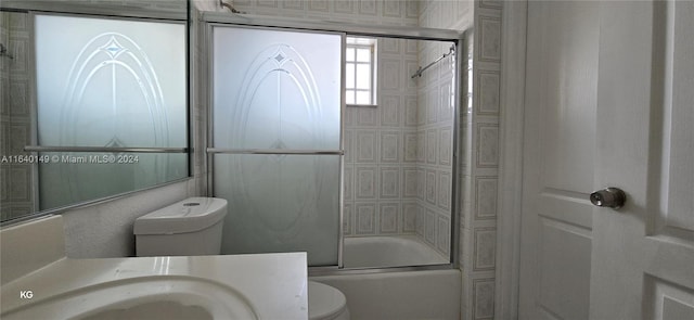 full bathroom featuring vanity, enclosed tub / shower combo, and toilet