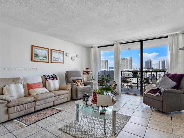 tiled living room with a textured ceiling and floor to ceiling windows