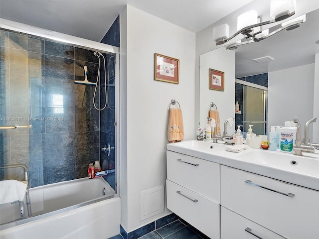 bathroom featuring combined bath / shower with glass door, tile patterned flooring, and dual vanity