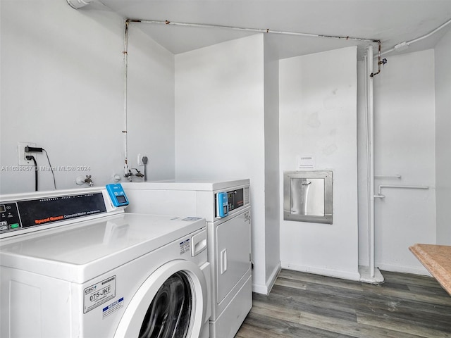 laundry room featuring separate washer and dryer and dark hardwood / wood-style flooring