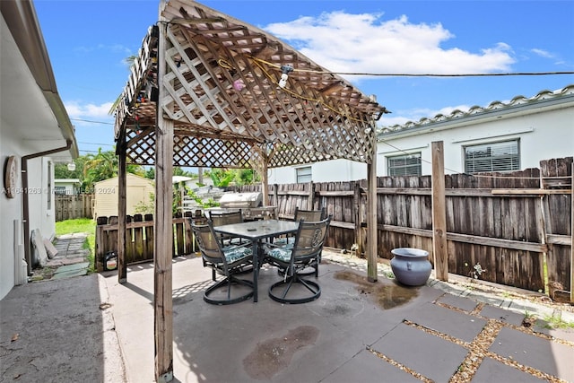 view of patio featuring a shed