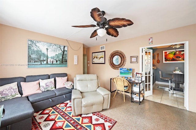 living area featuring french doors, visible vents, ceiling fan, and speckled floor