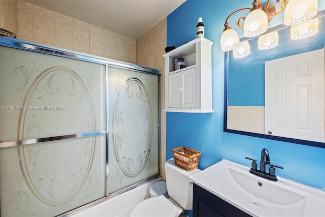 full bathroom featuring enclosed tub / shower combo, toilet, and vanity