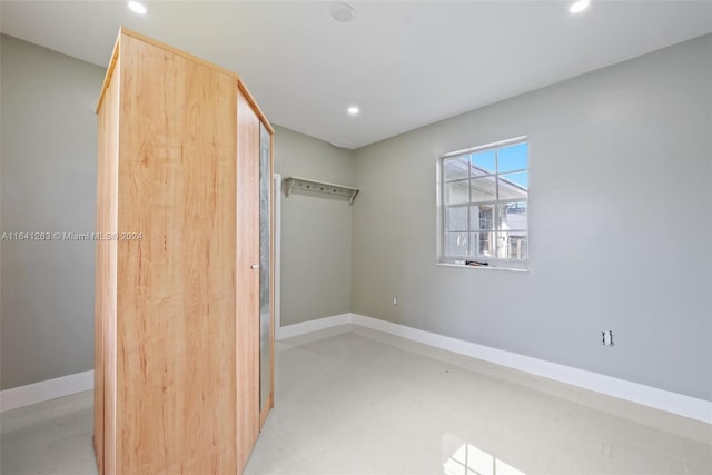 interior space with baseboards and recessed lighting